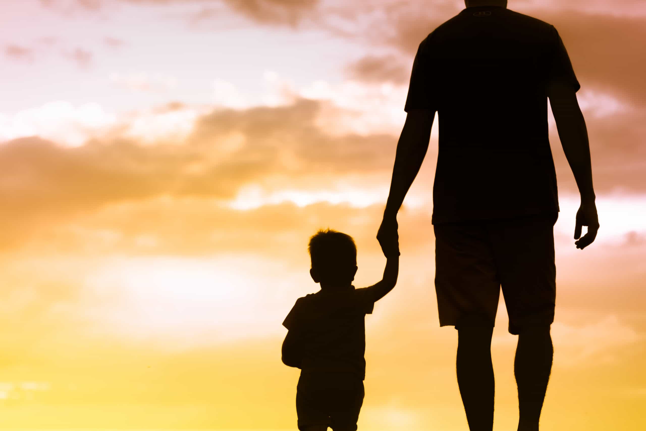 Father and son walking together holding hands